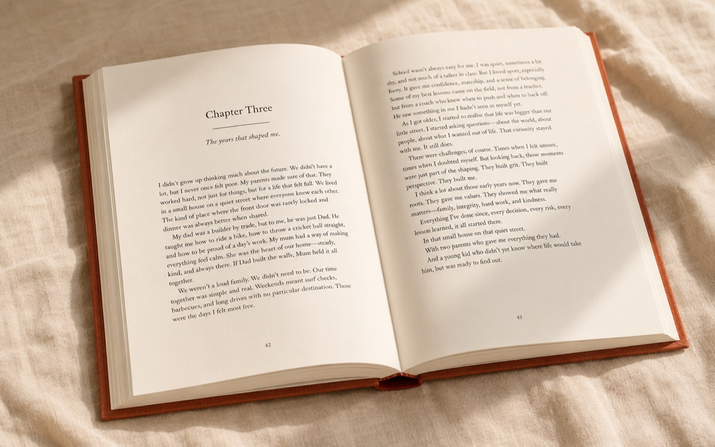 A finished Told book lying open to a chapter titled 'Chapter Three — The years that shaped me', showing professionally typeset memoir text